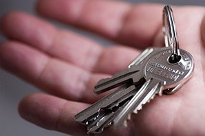 Car locksmith with car key ring in hand